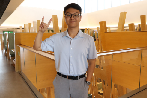 Alex Vu poses inside the Judy Genshaft Honors College