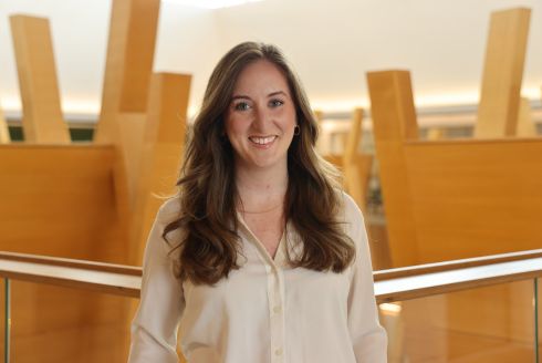 2025 USF Outstanding Young Alumni recipient Dr. Bailee Olliff poses in the Judy Genshaft Honors College building