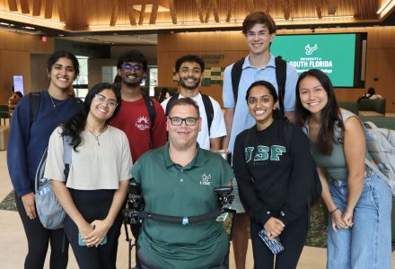 Kyle Romano poses with some of his students in the Honors atrium