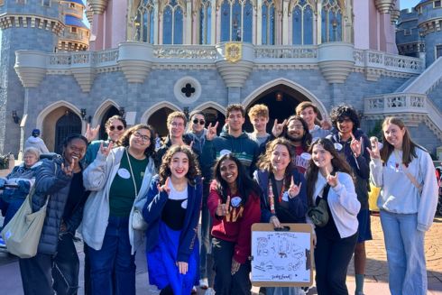 Tampa Honors LLC students proudly display their Judyland theme park design while showing their Bull pride in front of Cinderella Castle at Disney’s Magic Kingdom.