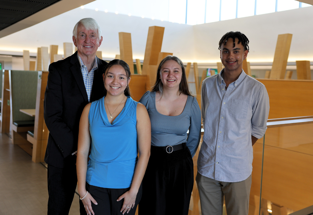 USF Provost Emeritus Ralph Wilcox and Wilcox Scholars Vanessa Quiroz, Sandra Napolitano, and Nico Lavaud pose in the Judy Genshaft Honors College building.