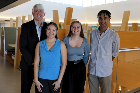 USF Provost Emeritus Ralph Wilcox and Wilcox Scholars Vanessa Quiroz, Sandra Napolitano, and Nico Lavaud pose in the Judy Genshaft Honors College building.