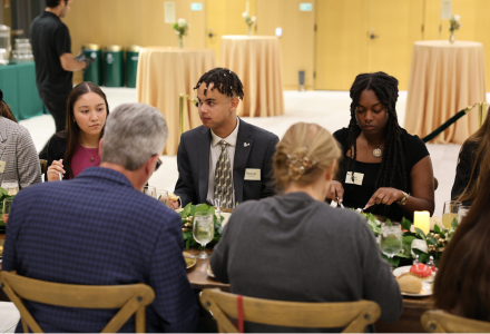 Wilcox Scholars engage in conversation at a dinner event