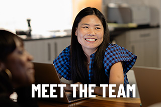 a woman smiles during a meeting with the words meet the team across the image