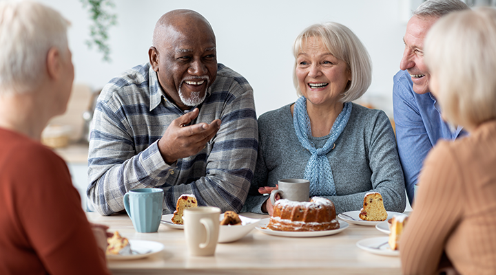 a group of elderly people smile at camera