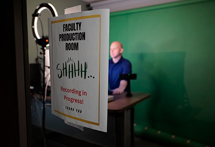 a door hangs on the front of the faculty production room saying HUSH recording in process