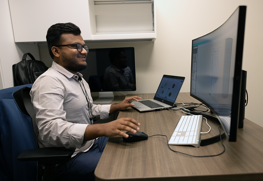 live support member sits at computer answering calls from faculty