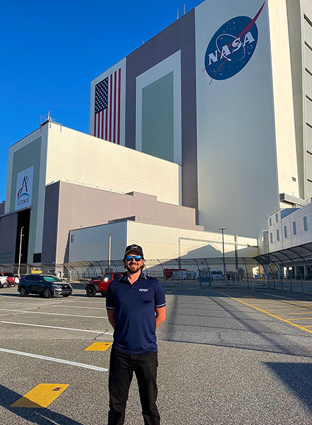 ryan staph stands in front of nasas vehical assembly building