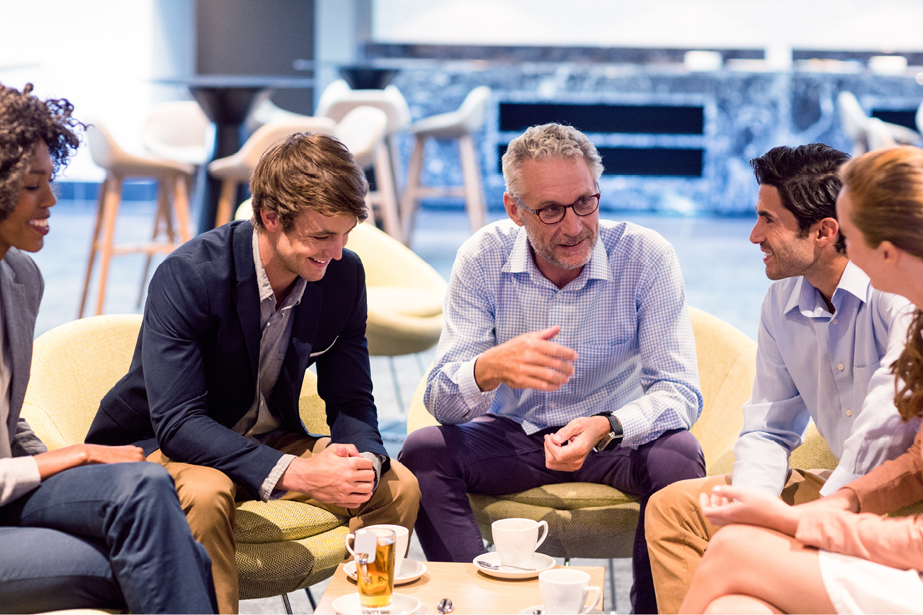 Employees sitting in a circle having a conversation. 