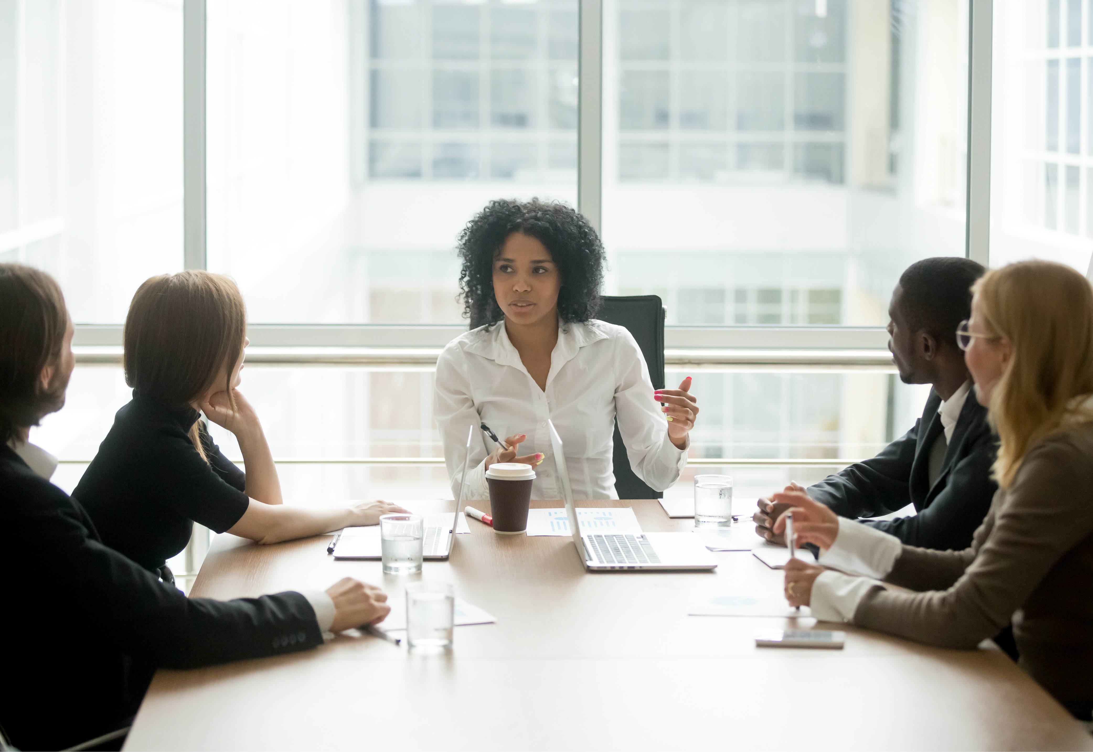 Professionals sitting around a table having a business meeting. 