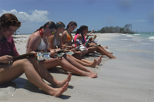 Campers doing beach water color paintings while at Shell Key.