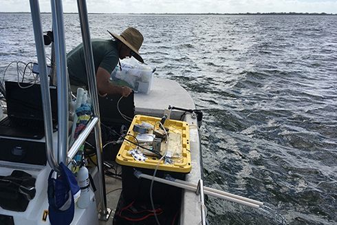 Chris Moore making adjustments to the automated, flow-through pH sampler out at the mouth of Tampa Bay. 