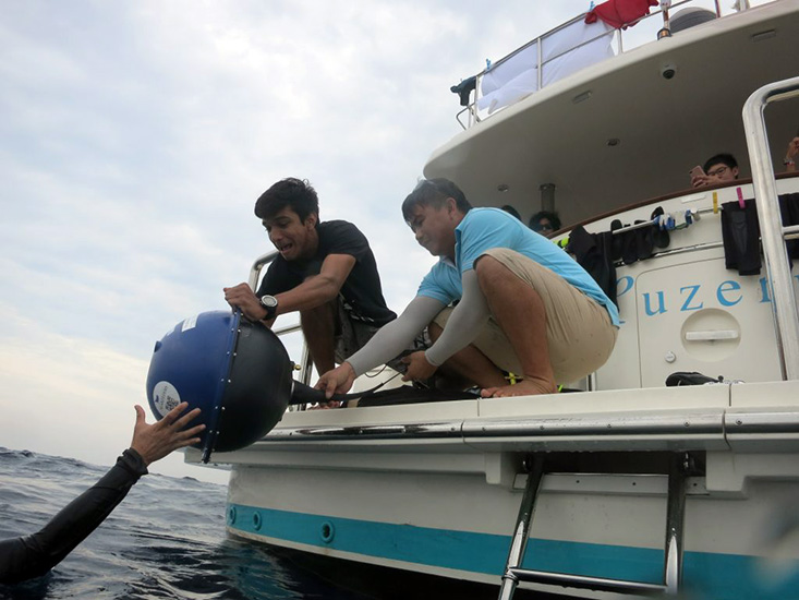 Crew deploys a surface drifter from the member yacht Luzern in the Indian Ocean