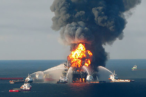 Oil spill responders attempting to extinguish the flames of the Deepwater Horizon platform at the onset of the accident in 2010. (Photo Credit: US Coast Guard) 