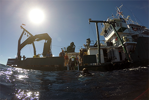 Research divers reboard the Weatherbird after visually examining the new buoy. (Photo credit: Jay Law) 