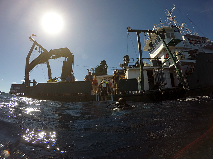 Research divers reboard the Weatherbird after visually examining the new buoy. (Photo credit: Jay Law) 