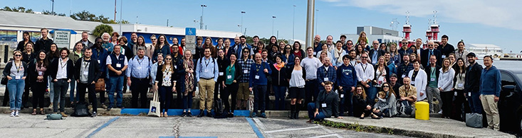 Participants of the Ecopath35 conference pose for a group photo on the seawall at the College of Marine Science. 