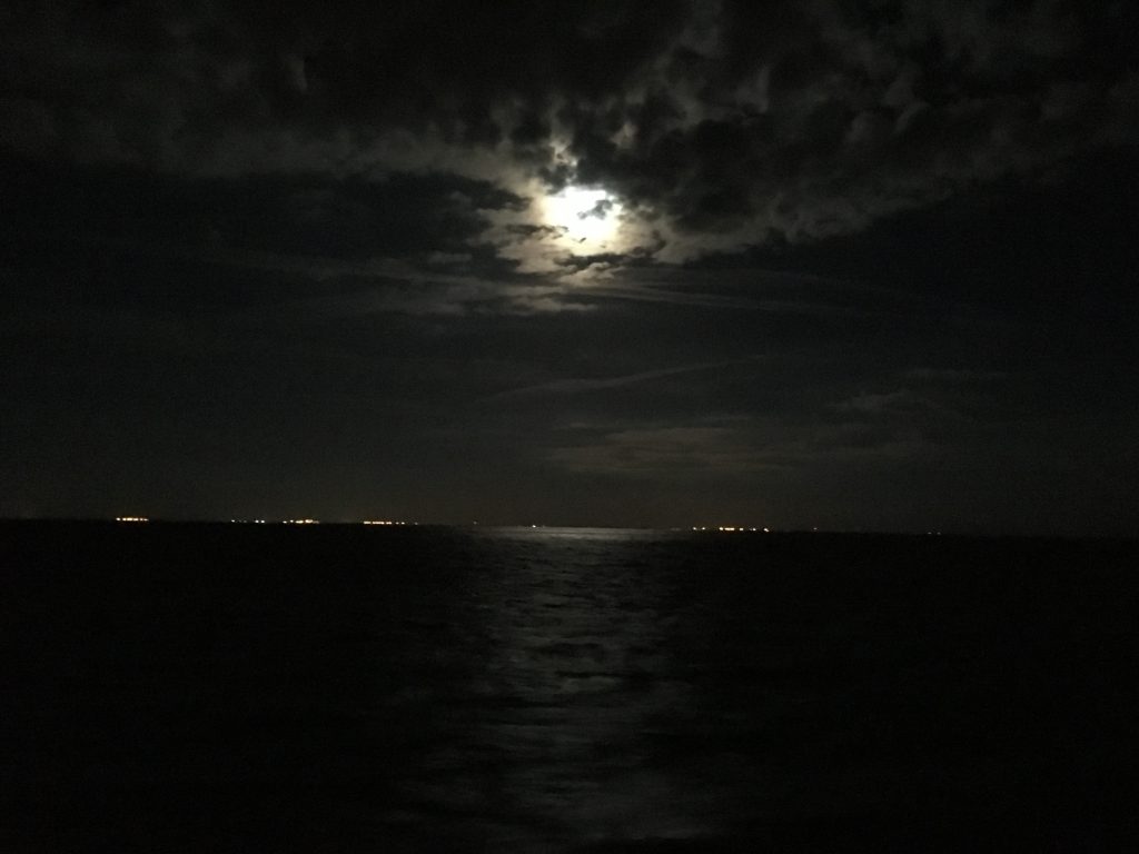 A full moon reflects across the waters of the Gulf of Mexico as the R/V Weatherbird II leaves Tampa Bay, FL.