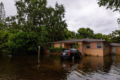 A home’s front lawn is flooded from heavy rains on Thursday, June 13, 2024, in Miami Shores, Florida. D.A. VARELA dvarela@miamiherald.com