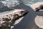 In this image from October 2024, the water is brownish as it leaves Little Sarasota Bay and flows through Midnight Pass into the lighter green waters of the Gulf.