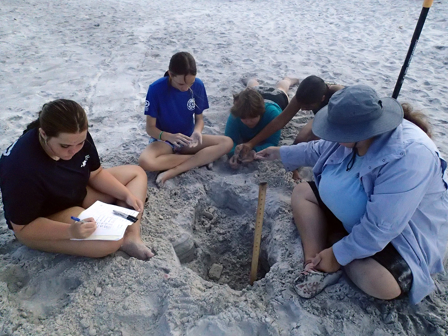 Campers take samples and make observations of the sediments in two semi-deep holes