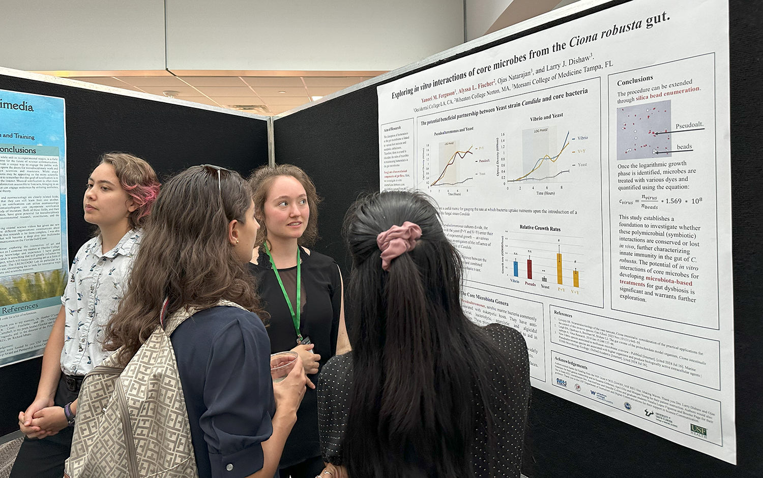 REU scholar Yanori Ferguson educates attendees about her research on microbes in the gut of sea squirts. Photo Credit: Jess Van Vaerenbergh