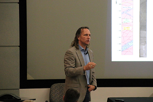 Sean Gulick, Ph.D., describes to the audience the rock content found in the drill cores of the Chicxulub crater. 