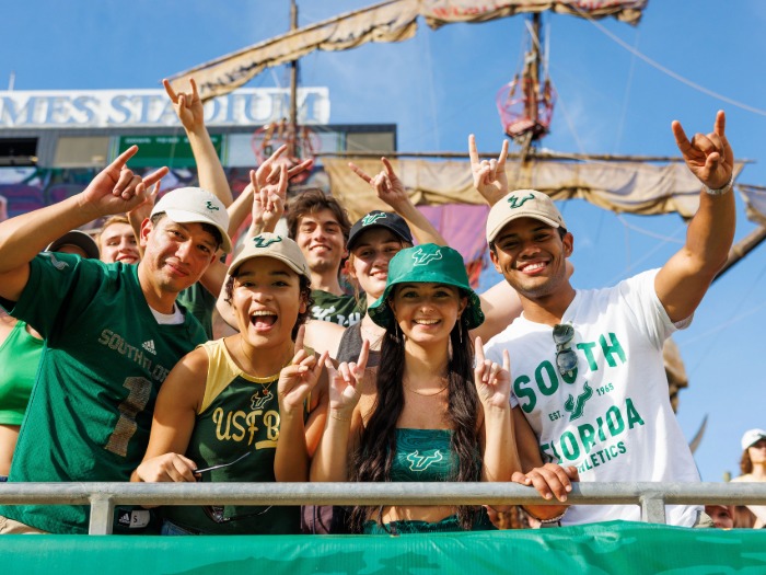A group of USF students doing Go Bulls hand gestures