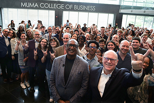 Group stands in Muma College of Business foyer