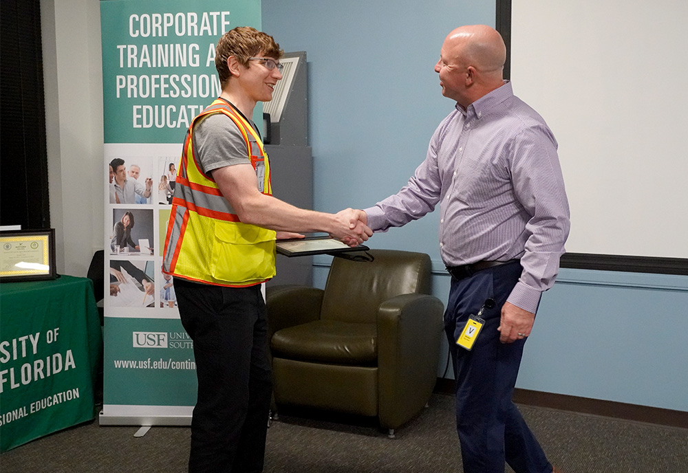 ctpe grad shakes hand of instructor