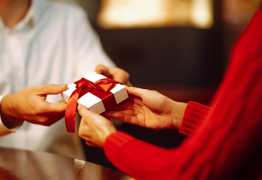 two people exchanging a gift