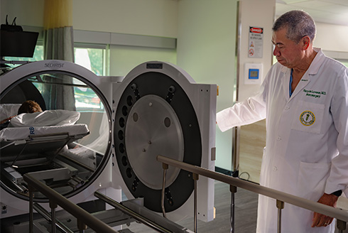 Dr. Harry van Loveren monitors patient in HBOT machines