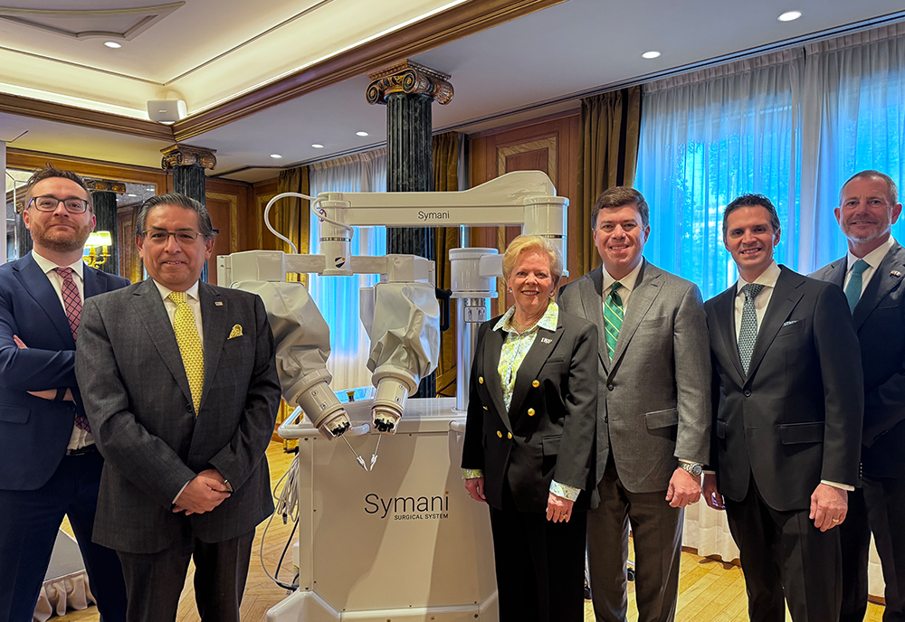 Representatives from USF Health, Tampa General Hospital and Medical Microinstruments post infront of the robotic technology