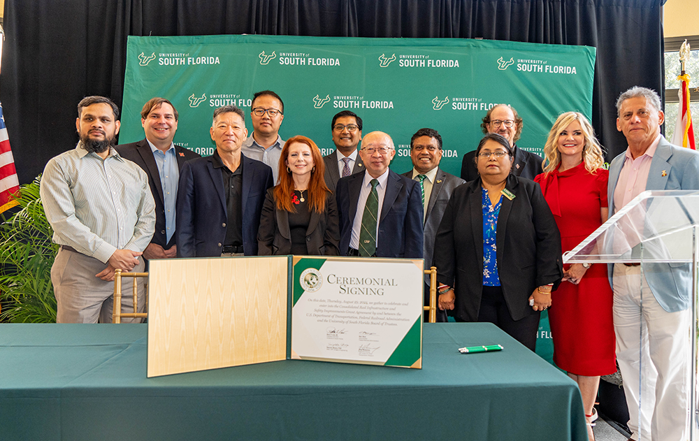 Group poses at signing ceremony