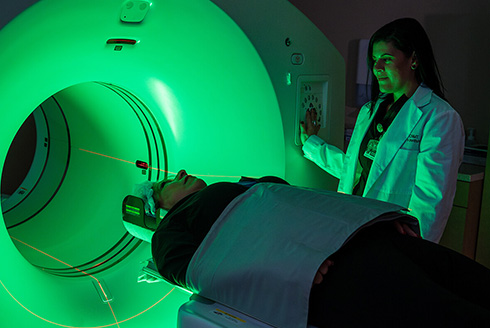 Doctor puts patient in MRI machine