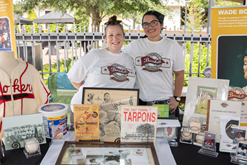 Two women at a table with archive materials