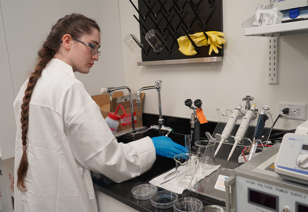 Student running experiments in lab to test dental implant's strength