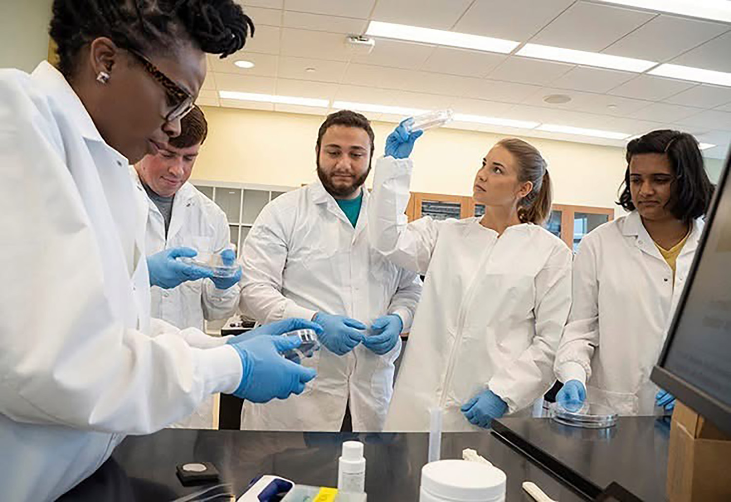 Rachel in the lab with her peers in 2019