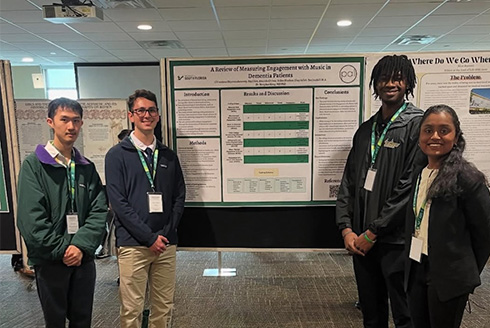 Students standing with their presentation