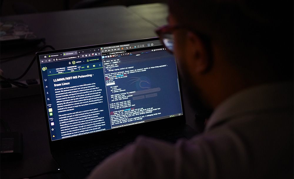 Man at computer with cybersecurity software on screen