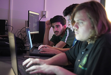 Students work on computer for cybersecurity class