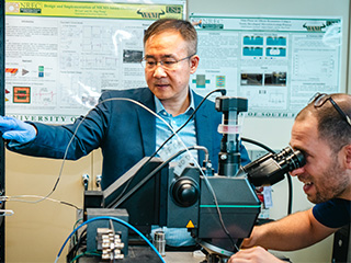 Jing Wang, professor of electrical engineering, and Ugur Guneroglu, graduate student