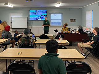 Christian Wells speaks to residents of the University Area