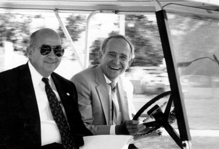 Charles Reed, the Chancellor for the State University System of Florida, came to USF to talk with President Francis Borkowski and to see the USF campus in 1989. in this photo, Reed (in sunglasses) and Borkowski travel across the campus in a golf cart. | Source: USF Digital Commons