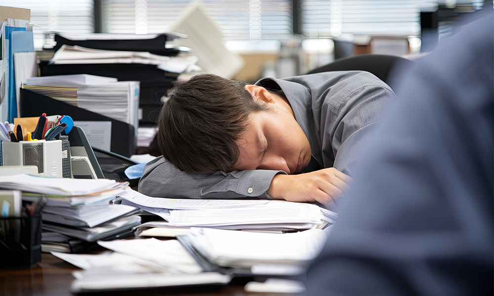 Man naps at his desk