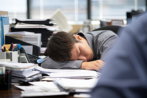 Man naps at his desk