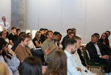 Attendees in the crowd ask the panel questions