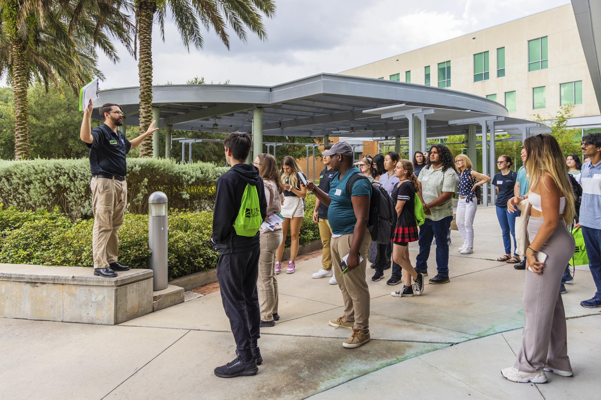 USF Freshmen students attending orientation on campus and holding up the bulls sign.