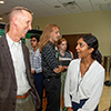 lorida High Tech Corridor CEO Paul Sohl speaks with female undergraduate researcher during USF's Summer AIR Symposium.