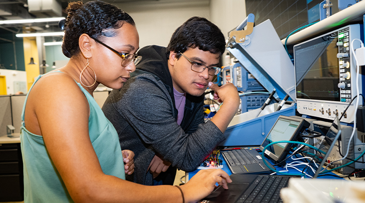 female and male student work together on an engineering research project in the lab
